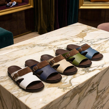 Collection of colorful Arabic sandals displayed on a table.