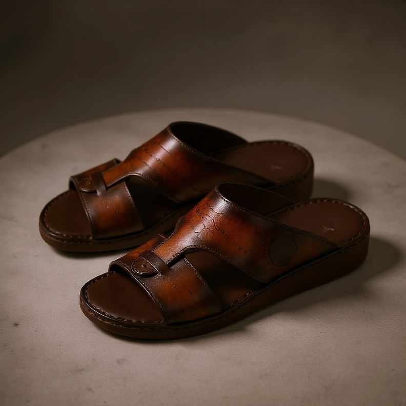Brown patterned Arabic sandals on marble