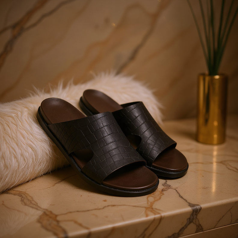 Dark brown leather sandals on a marble surface.